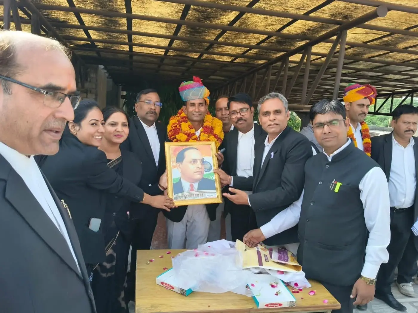 Advocates presenting a framed portrait of Dr B. R. Ambedkar at a Bar function attended by Manoj Kumar Ajmera